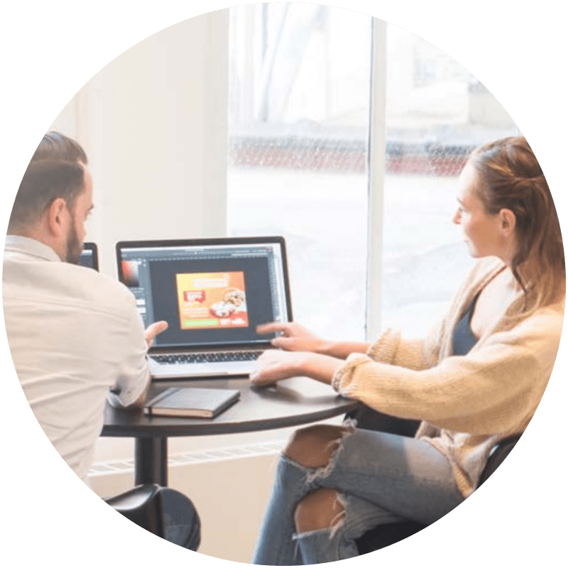 man and woman using laptop